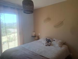 a stuffed animal sitting on a bed in a bedroom at T4 Villa SOTTA entre mer et montagnes in Sotta
