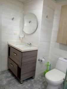a bathroom with a sink and a toilet and a mirror at Apartamento Fontana 2 in Bucaramanga +28 photos