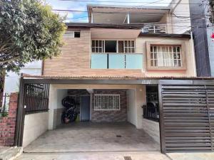 a house with a garage in front of it at Apartamento Fontana 2 in Bucaramanga
