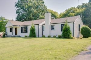 a white house with a grass yard at Nashville's Music City House, Dolly Approved! in Nashville