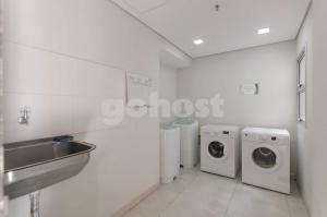 a bathroom with three washing machines and a sink at Comfortable Villa Morra Loft in Asuncion