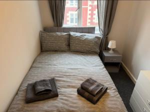a bedroom with a bed with two towels on it at 118 NELSON STREET 1st FLOOR , LARGS in Largs