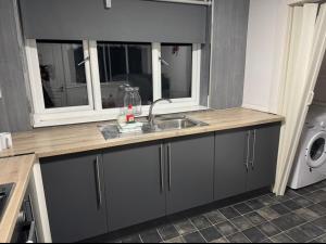 a kitchen counter with a sink and a window at 118 NELSON STREET 1st FLOOR , LARGS in Largs