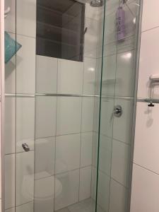 a shower with a glass door in a bathroom at Studio Memphis in El Prado in Cochabamba +14 photos