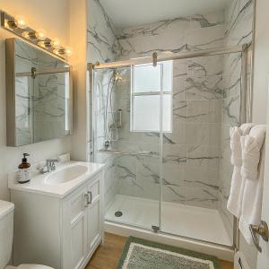 a bathroom with a shower and a sink at Beautiful Chicago 2BD 1BA in Chicago +21 photos