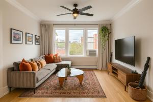 a living room with a couch and a flat screen tv at Beautiful Chicago 2BD 1BA in Chicago