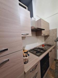 a kitchen with wooden cabinets and a stove top oven at Casa Conti Trivelli in Vasto