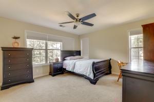 a bedroom with a bed and a ceiling fan at 4 Mi to Chattahoochee River Family Home with Yard! in Roswell