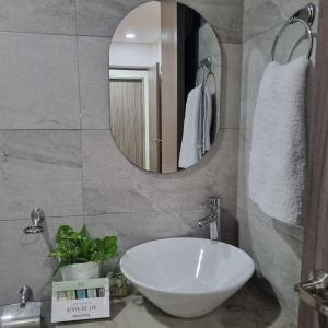 a bathroom with a white sink and a mirror at Hotel Patiño Boutique in Montería +14 photos