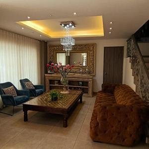 a living room with a couch and a table at Hotel Patiño Boutique in Montería