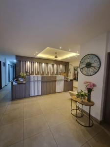 a lobby with a large clock on the wall at Hotel Patiño Boutique in Montería