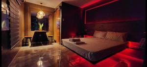a bedroom with a bed with red lights on it at GRG Villa Huan in Santo Domingo +24 photos