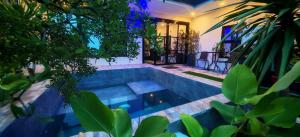 a swimming pool in the middle of a house with trees at GRG Villa Huan in Santo Domingo