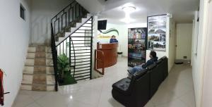 a man sitting in a chair in a store at Hostal Caxamarcorco in Cajamarca