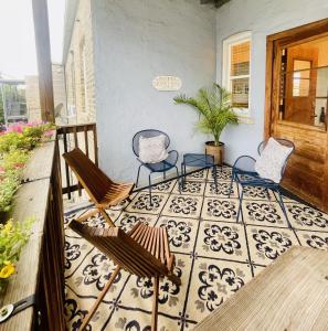 a porch with three chairs and a tile floor at Beautiful Chicago 2BD 1BA in Chicago