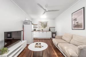 a living room with a couch and a table at Beach Shack No. 7 in Crescent Head +2 photos