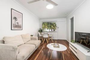 a living room with a couch and a table at Beach Shack No. 7 in Crescent Head