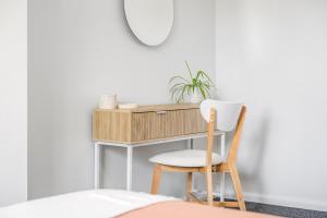 a desk in a bedroom with a chair and a mirror at Beach Shack No. 6 in Crescent Head