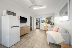 a living room with a couch and a refrigerator at Beach Shack No. 6 in Crescent Head
