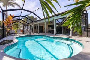 a swimming pool in the middle of a house at Coconut Breezes near Anna Maria Island in Bradenton