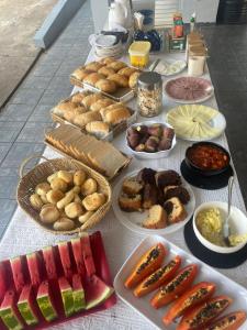 a table with many different types of food on it at Hotel Torre Forte in Careiro
