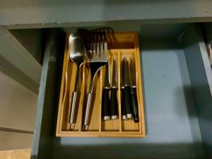 a group of utensils in a wooden holder at Pedro's Heights 2 Bed, 1 Bath in Tumon