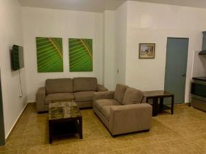 a living room with a couch and a table at Pedro's Heights 2 Bed, 1 Bath in Tumon