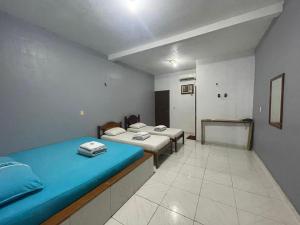 a room with two beds in a room at Hotel Torre Forte in Careiro