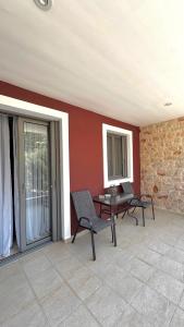 a patio with two chairs and a table in a room at Anesis home in Gythio