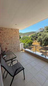 a balcony with a chair and a table and a view at Anesis home in Gythio