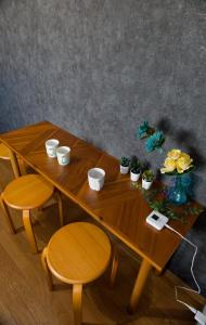 a wooden table with two chairs and plants on it at G63 駅徒歩3分 3人可能 名古屋駅から1駅 3-minute walk from the station in Nagoya