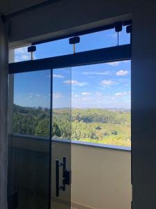 a window in a building with a view of a field at Hotel Rezende in Villa Nova de Resende