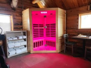 a bathroom with a pink door in a room at Elk Antler Inn in Thermopolis