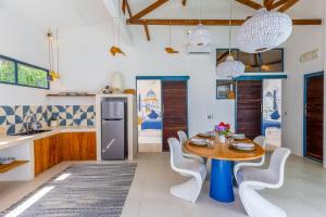 a kitchen and dining room with a table and chairs at Santorini Suites Canggu in Canggu