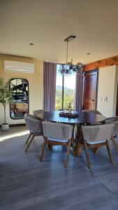 a dining room with a wooden table and chairs at Casa Sekui in Chivato
