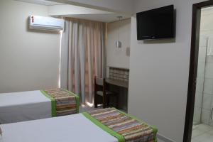 Ένα ή περισσότερα κρεβάτια σε δωμάτιο στο Paiaguas Palace Hotel