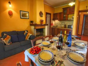 a living room with a table and a couch at Attractive mansion with pool in Cignano