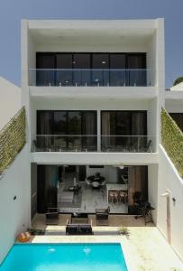 an exterior view of a house with a swimming pool at Perla 8- Exclusiva Moderna Villa 4 Habitaciones y Piscina in Sosúa