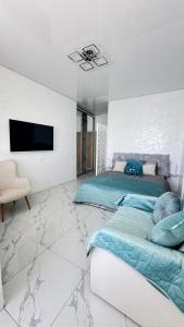a bedroom with a bed and a flat screen tv at Вид на море, ЖК Avinion in Odesa