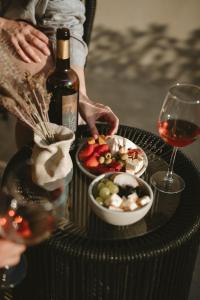a table with a bottle of wine and a bowl of fruit at Equ Hotel Boutique in El Porvenir +68 photos