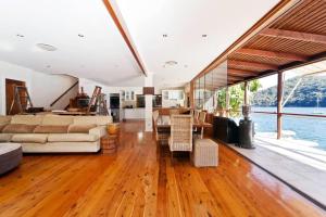 a large living room with a bed and a dining room at Cottage Point - Paradise Found in Berowra