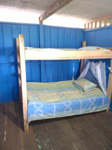 two bunk beds in a room with blue walls at Cabaña La Paisana in Buenaventura