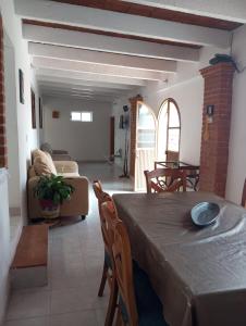 a living room with a table and a couch at Los Malvones in Tequisquiapan +8 photos