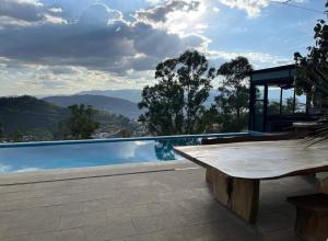a pool with a table and a view of the mountains at Spectacular Igloo-style House in Oaxaca City