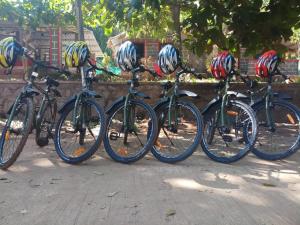 a group of bikes parked next to each other with helmets on them at Jungle inn Stay in Dandeli