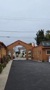 a brick building with an archway in a parking lot at Sunny Cove Motel in Santa Cruz