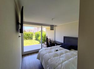 a bedroom with a bed and a large window at Brisas de Puyai apartment for 5 people in Lilén +19 photos