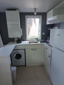 a small kitchen with a sink and a dishwasher at Camping DEL MAR in Argelès-sur-Mer +8 photos