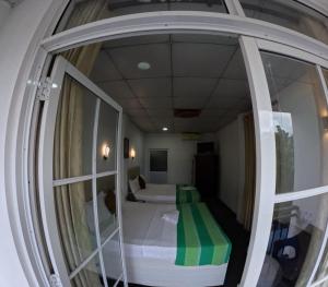 a small room with a bed and a window at Villa Rivora in Kitulgala +24 photos