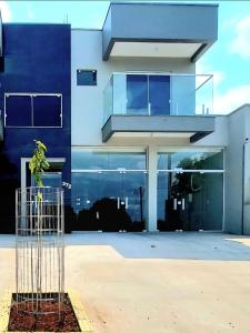 Un edificio azul con una planta en una jaula. en Apartamento novo - 2 Quartos Casal até 4 pessoas - Centro - Santa Rosa - RS, en Santa Rosa 3 fotos más